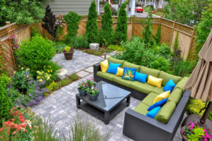A beautiful small, urban backyard garden featuring a tumbled pav